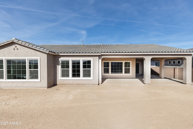 rear view of property featuring a patio area