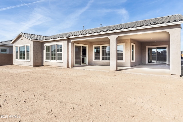 back of property with a patio