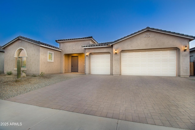 22665 E Stacey Rd, Queen Creek, AZ 85142 - view of front facade featuring decorative driveway, stucco siding, a garage, and a tiled roof