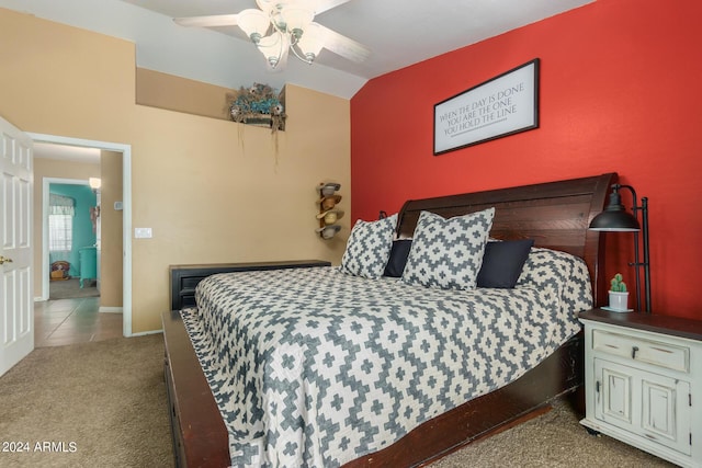 carpeted bedroom featuring vaulted ceiling and ceiling fan