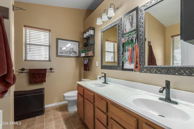 bathroom with vanity, tile patterned flooring, and toilet