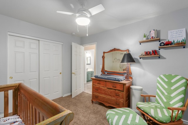 carpeted bedroom with ceiling fan and a closet