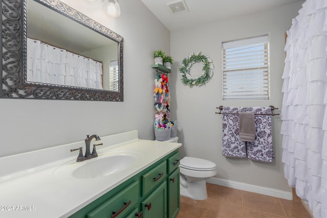 bathroom featuring vanity, tile patterned floors, and toilet