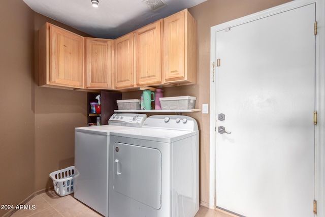 laundry area featuring independent washer and dryer and cabinets