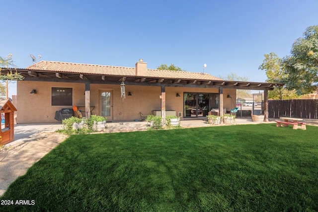 rear view of house featuring a yard and a patio area