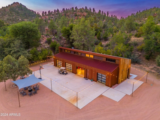 view of front of property featuring a mountain view and a patio area