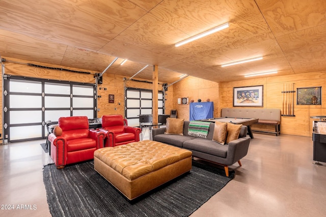 interior space with concrete floors and wood walls