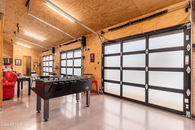 game room with wood ceiling, lofted ceiling, and concrete flooring