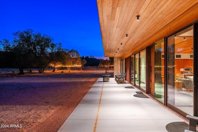 view of patio terrace at dusk