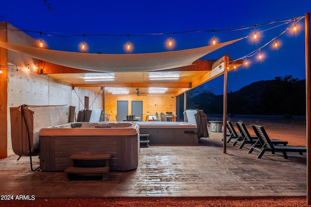 patio at night with a hot tub