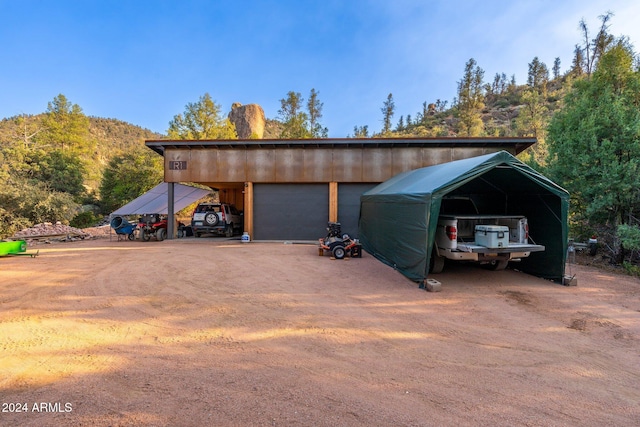 garage with a mountain view and a carport