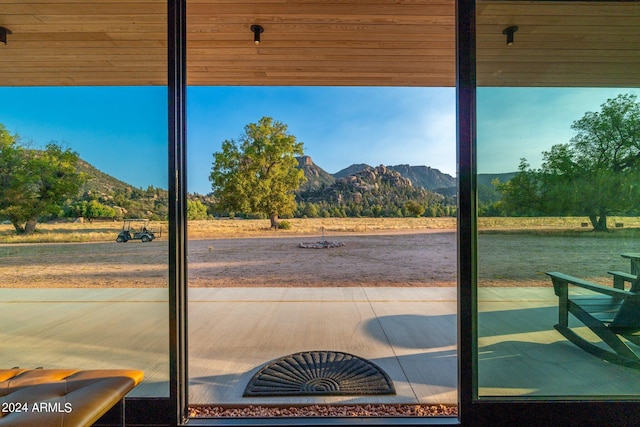 doorway with a mountain view and wood ceiling