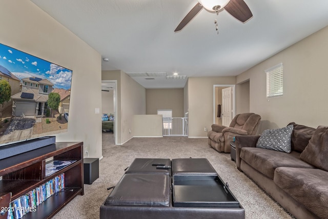 carpeted living room with baseboards, ceiling fan, and a healthy amount of sunlight
