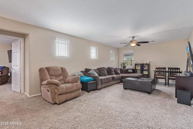 living area with carpet floors, baseboards, ceiling fan, and visible vents