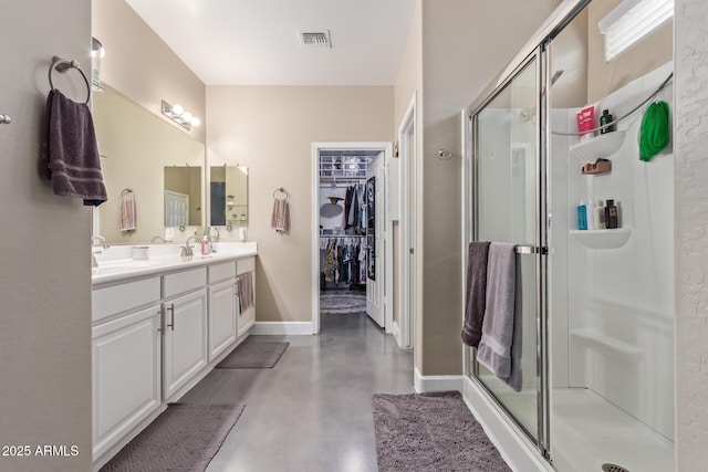 bathroom featuring visible vents, finished concrete flooring, a shower stall, vanity, and baseboards