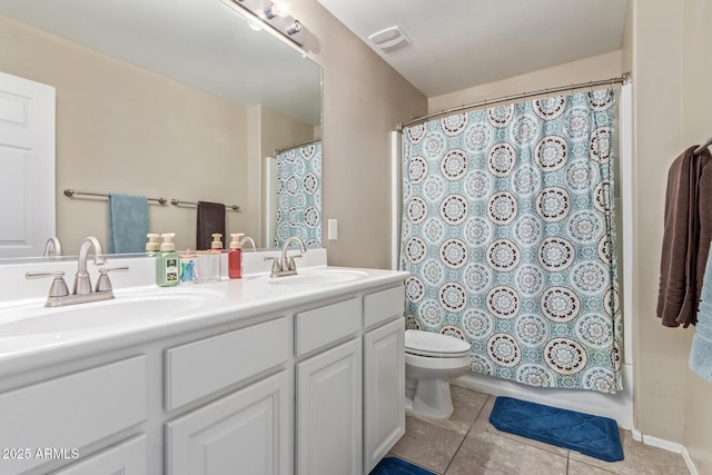 bathroom featuring toilet, tile patterned floors, visible vents, and a sink