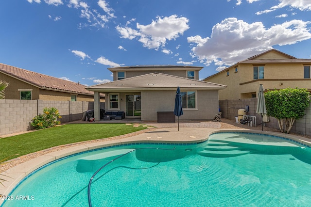 view of swimming pool with a lawn, a patio, a fenced in pool, and a fenced backyard