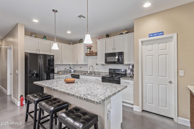 kitchen featuring backsplash, a sink, baseboards, black appliances, and concrete floors
