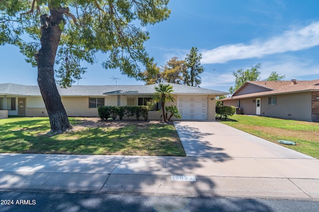 ranch-style home with a garage and a front yard