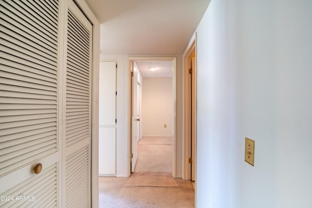 hall featuring light colored carpet