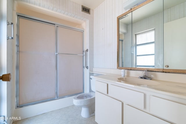 bathroom featuring walk in shower and vanity