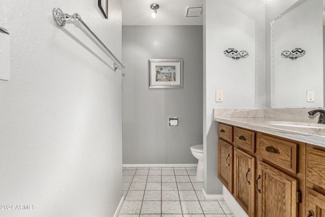 bathroom with vanity, tile patterned flooring, and toilet