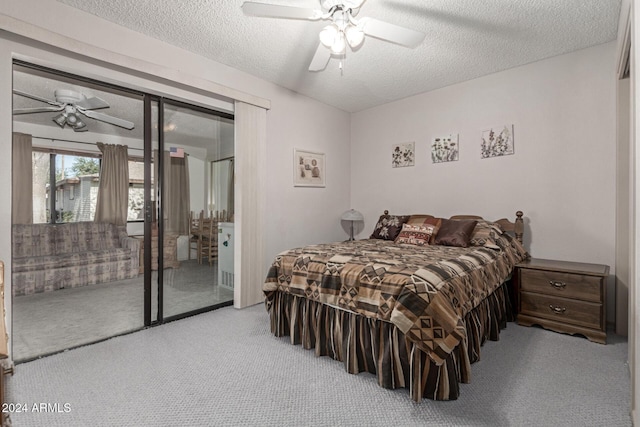 carpeted bedroom featuring ceiling fan, access to exterior, and a textured ceiling