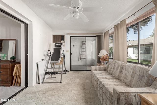 interior space featuring ceiling fan, light colored carpet, and a textured ceiling