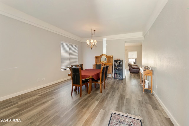 dining area with hardwood / wood-style flooring and a chandelier