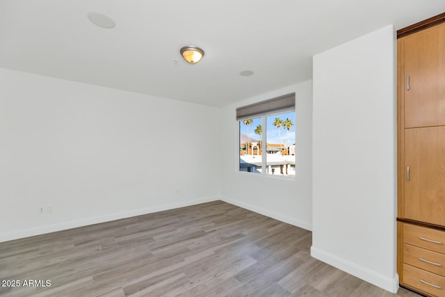 unfurnished room with light wood-type flooring