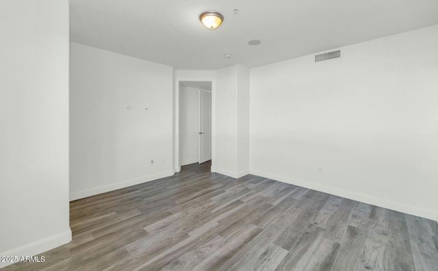 spare room with light hardwood / wood-style flooring