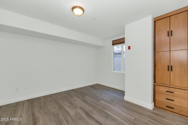 unfurnished bedroom with light wood-type flooring