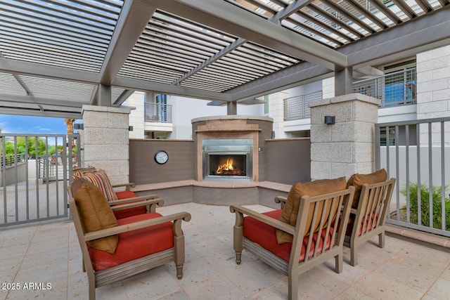 view of patio / terrace featuring exterior fireplace and a pergola