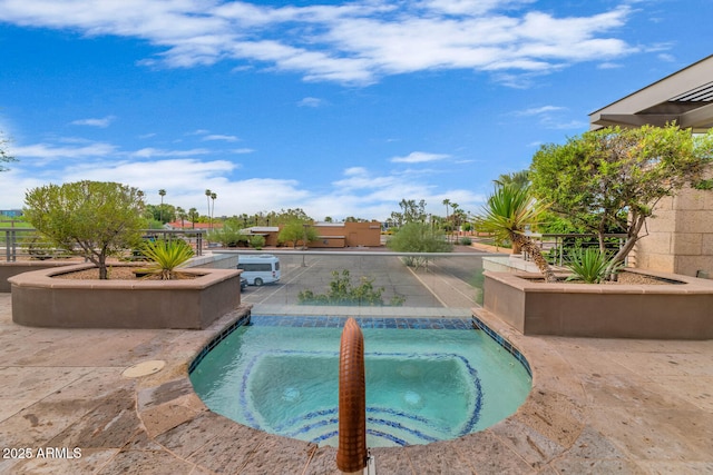 view of swimming pool with an in ground hot tub and a patio