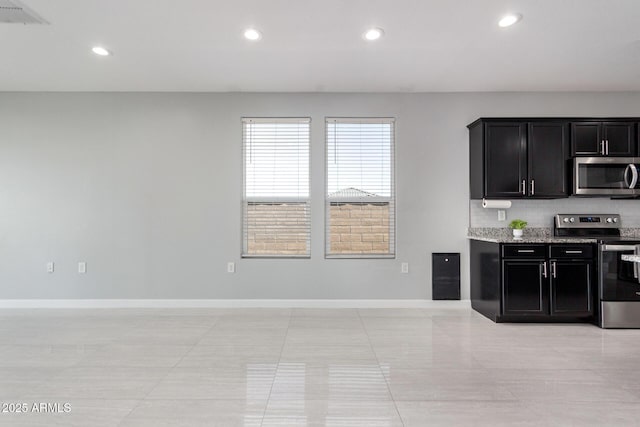 kitchen featuring dark cabinetry, recessed lighting, baseboards, and stainless steel appliances