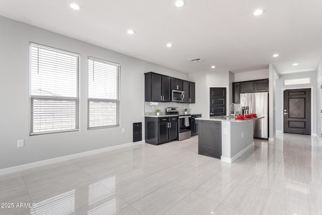 kitchen featuring visible vents, baseboards, recessed lighting, appliances with stainless steel finishes, and a sink