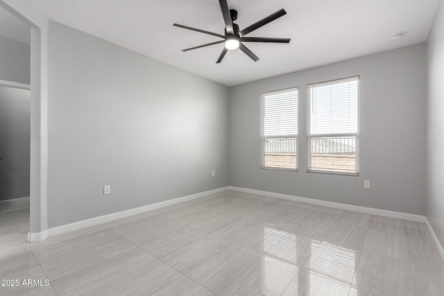 empty room with baseboards and ceiling fan