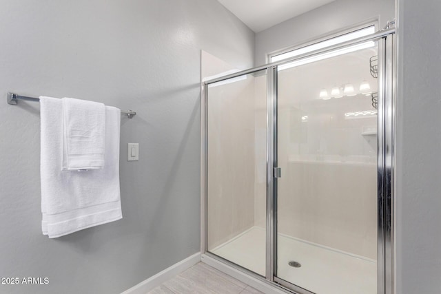 bathroom featuring baseboards and a stall shower