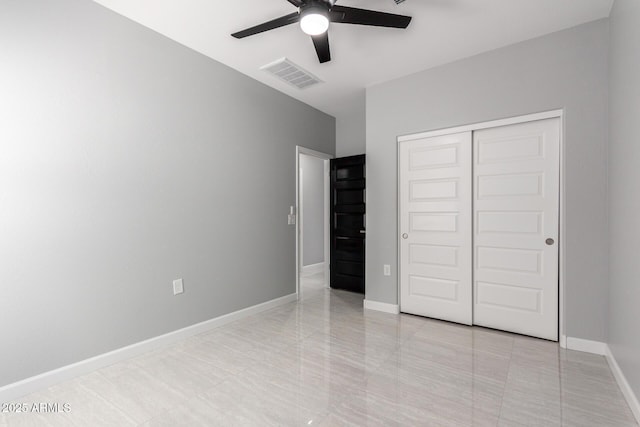 unfurnished bedroom with baseboards, visible vents, a closet, and ceiling fan