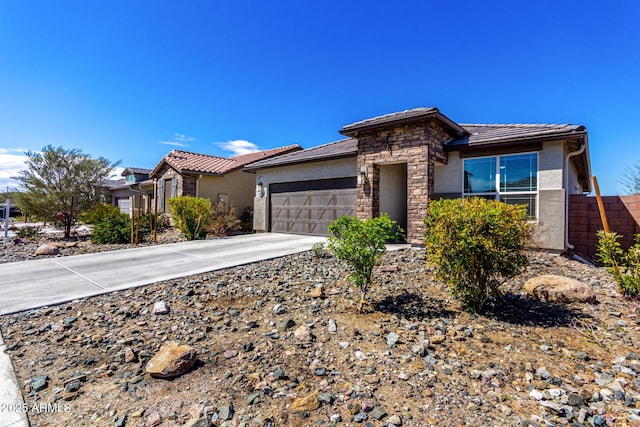 view of front facade featuring an attached garage, stone siding, driveway, and stucco siding