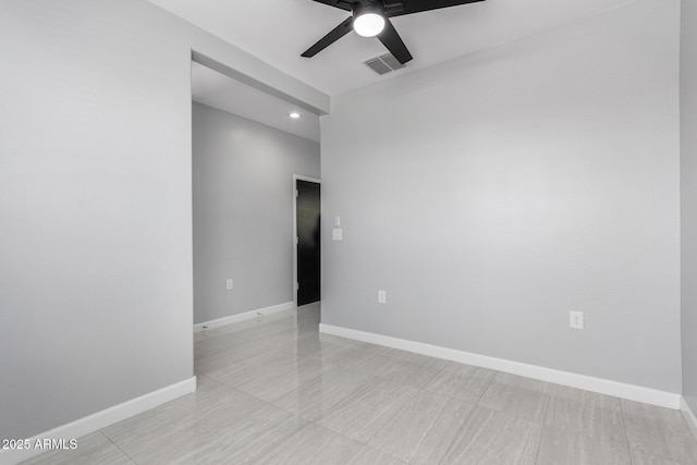 empty room with visible vents, ceiling fan, and baseboards