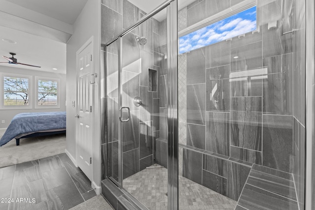 bathroom featuring walk in shower and ceiling fan