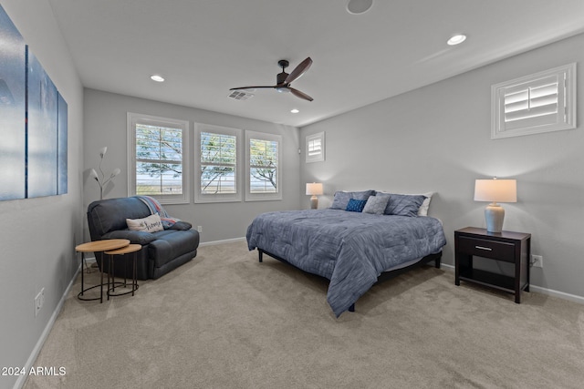 bedroom with ceiling fan and light colored carpet