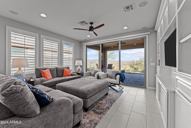 living room featuring ceiling fan and light tile patterned floors