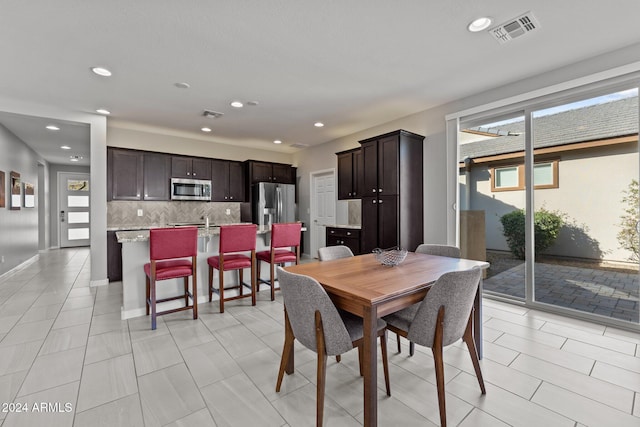 tiled dining area featuring a healthy amount of sunlight