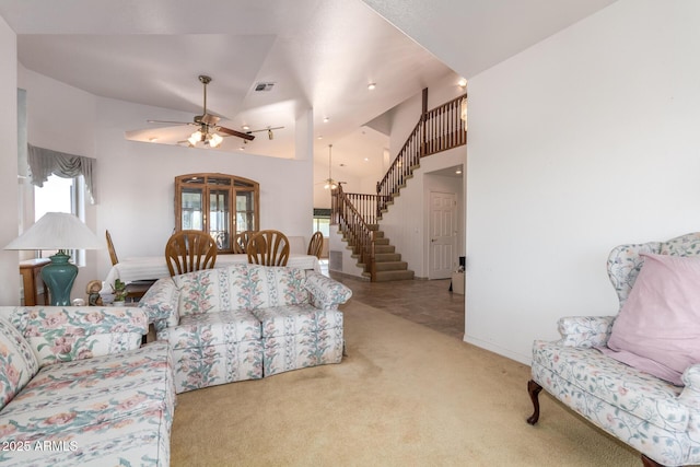 carpeted living room featuring ceiling fan and high vaulted ceiling