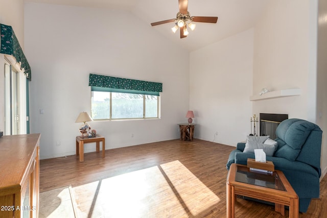 living room with wood-type flooring, high vaulted ceiling, and ceiling fan