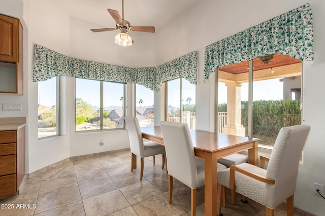 tiled dining space featuring ceiling fan