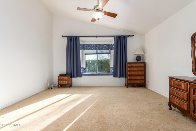 unfurnished bedroom featuring vaulted ceiling, light colored carpet, and ceiling fan