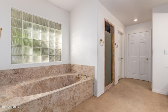 bathroom featuring shower with separate bathtub